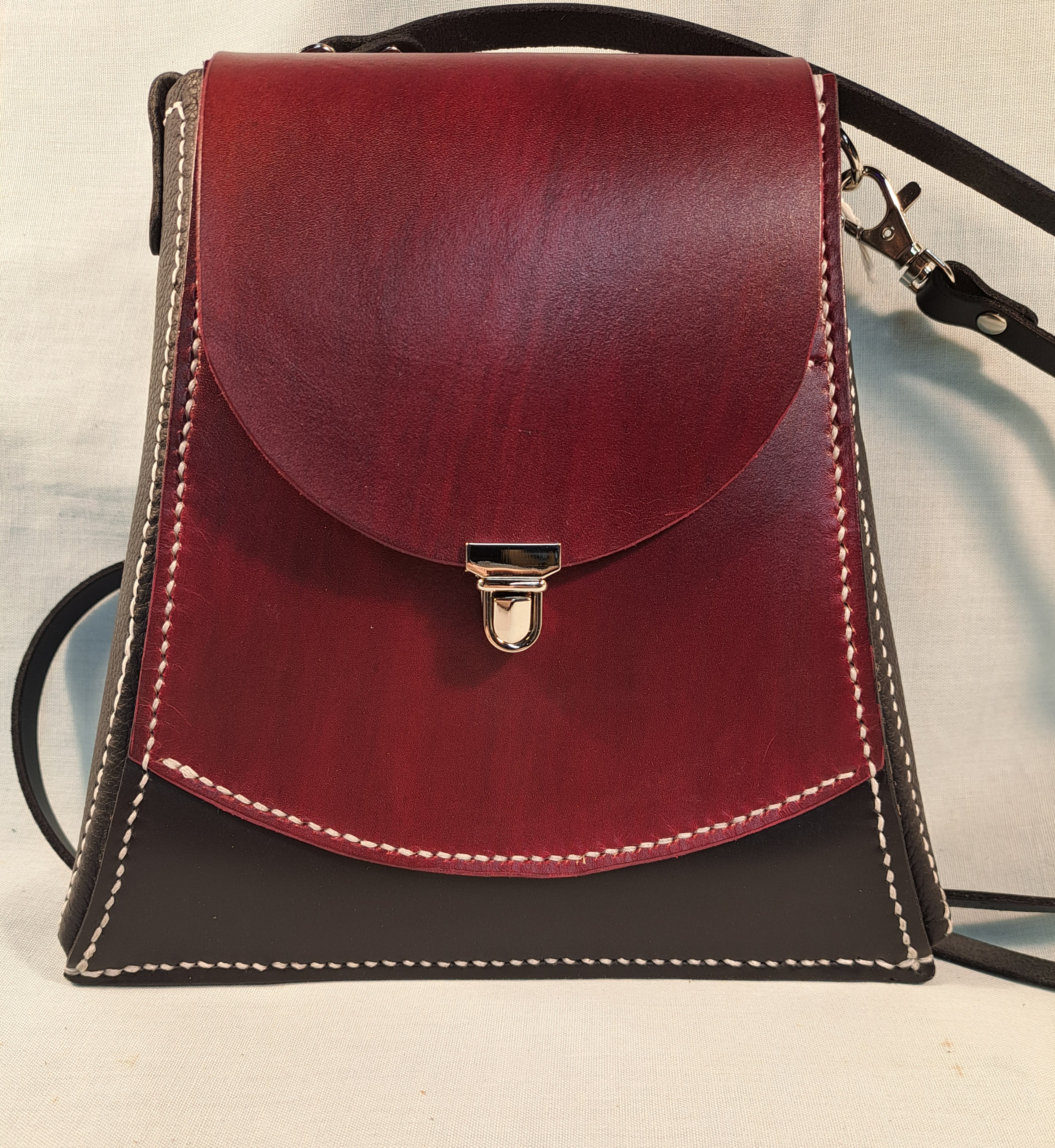 A small red and black leather purse