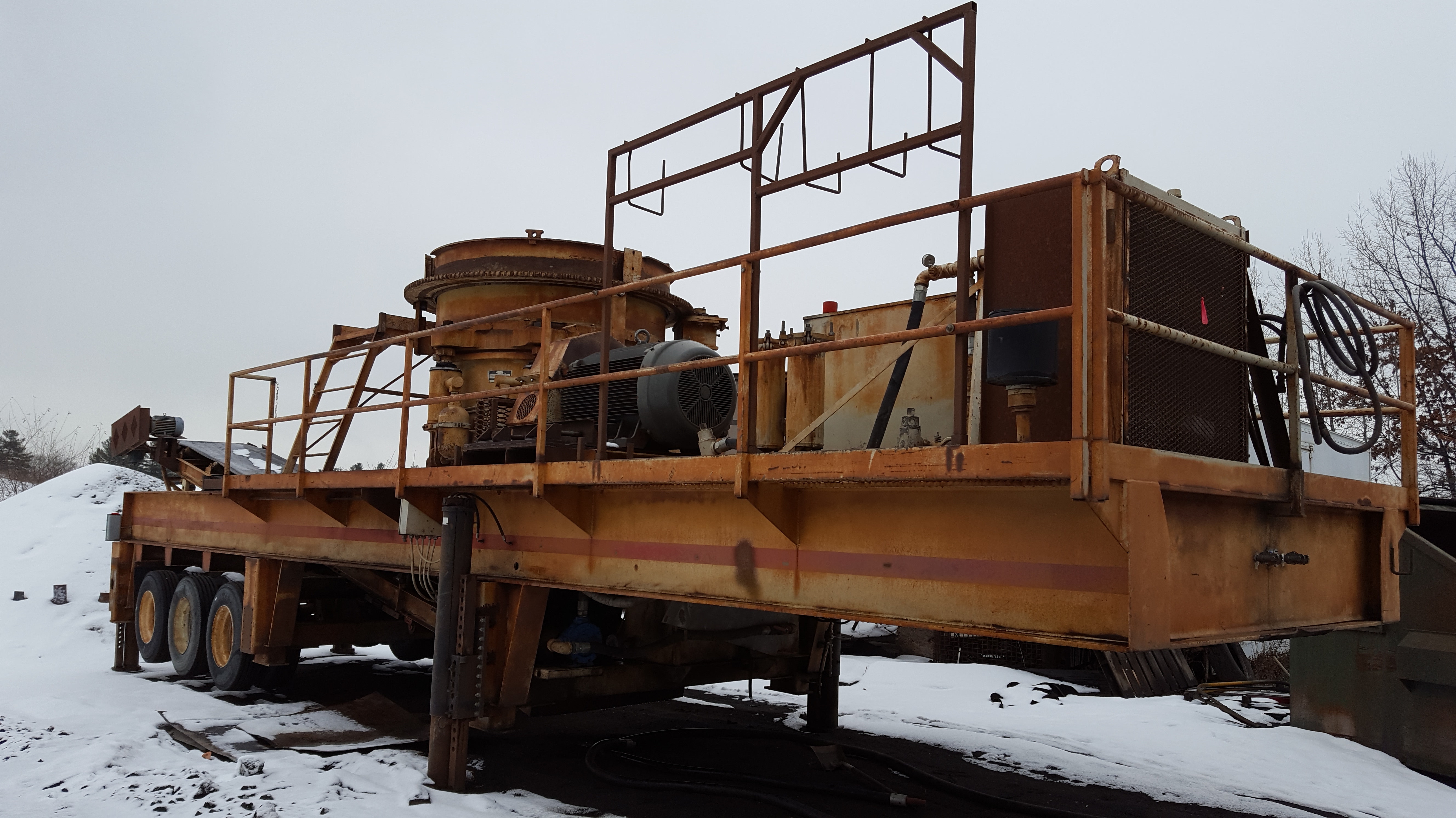 A rock crusher in for sandblasting and paint.