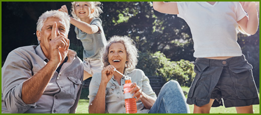 Grandparents and grandkids playing outside in the sunshine