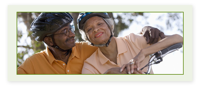 A senior couple with bike helmets on