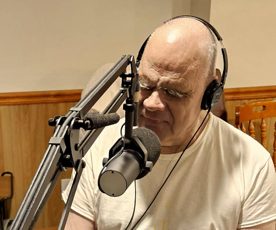 Sam sitting at his broadcast radio console.