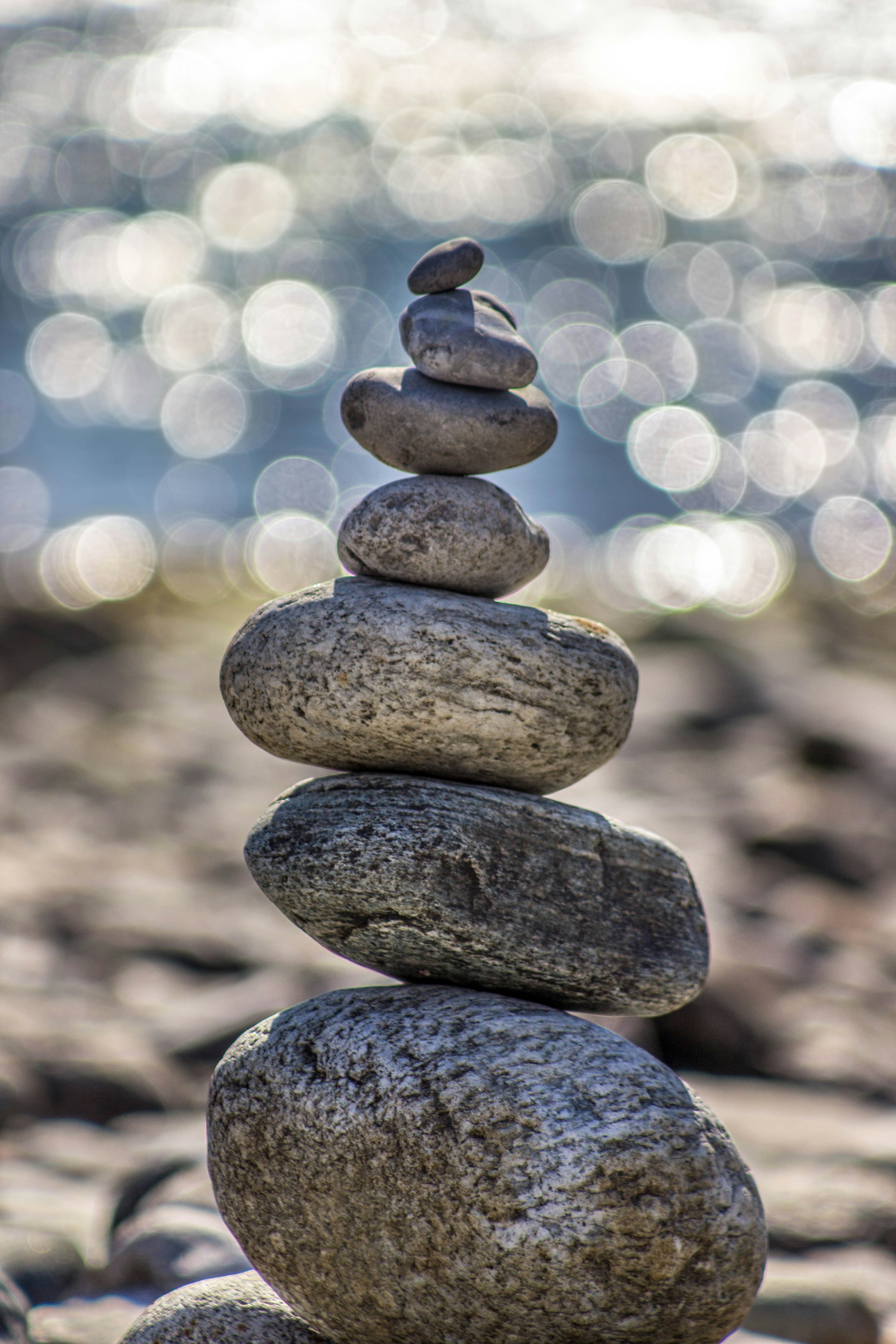 Stack of smooth balancing stones with blurred bokeh background