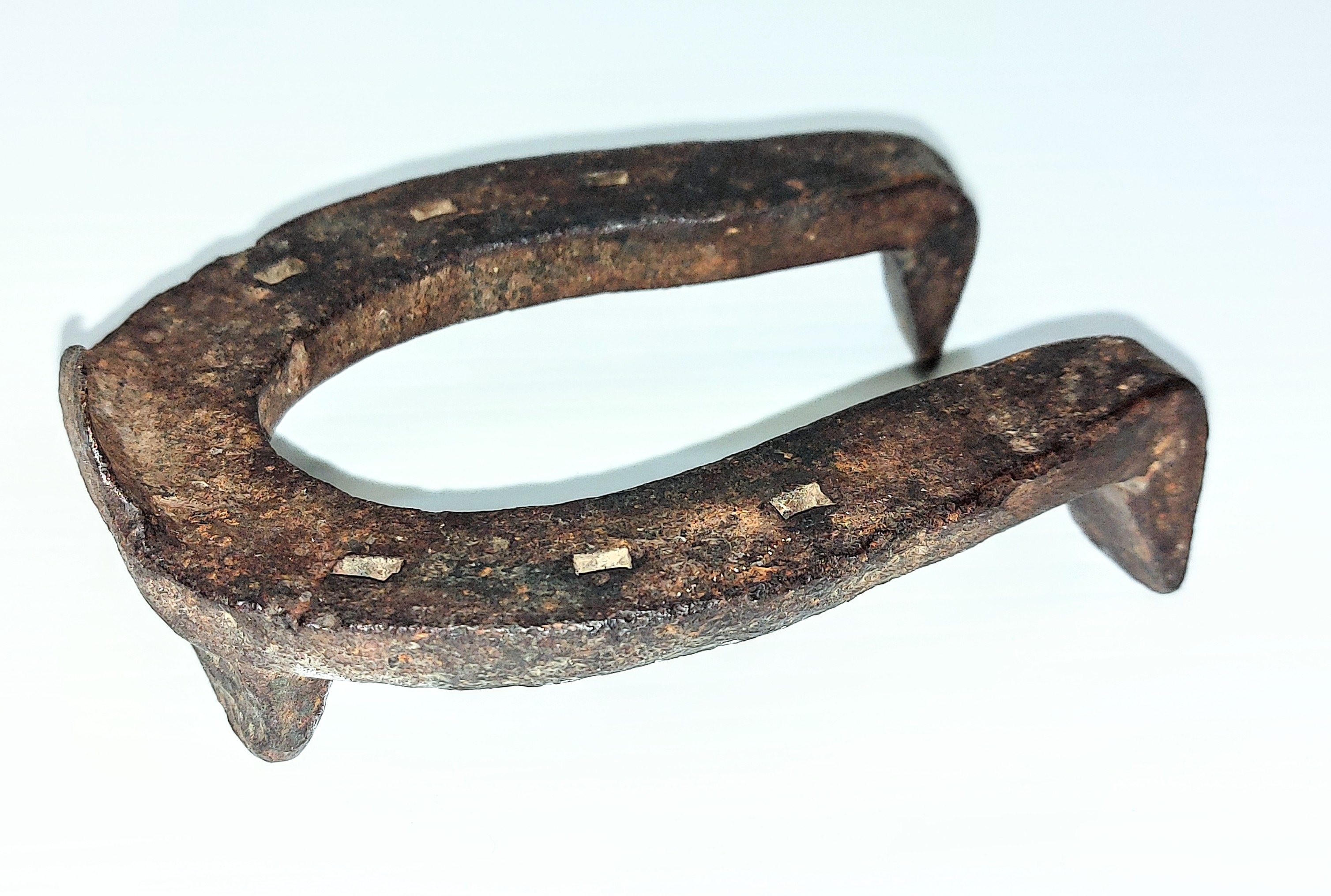 This is a small (it's only 10cm X 7cm) ice or "pulling" horseshoe. The shape is the same as regular horseshoes but also has 3 large spikes - one on the front near the toe and two on the back. These spikes provide extra traction in icy conditions or when pulling heavy loads. Horses used by Louis Bourassa on the mail route, or those used by Jack Whitehouse or Frank Flett in hauling water throughout the community likely would have used such a shoe in the winter season. Horses were also used to move buildings in the community and may have been shod with such a shoe.
2007.61.17 / Tourangeau Martha + Harvey