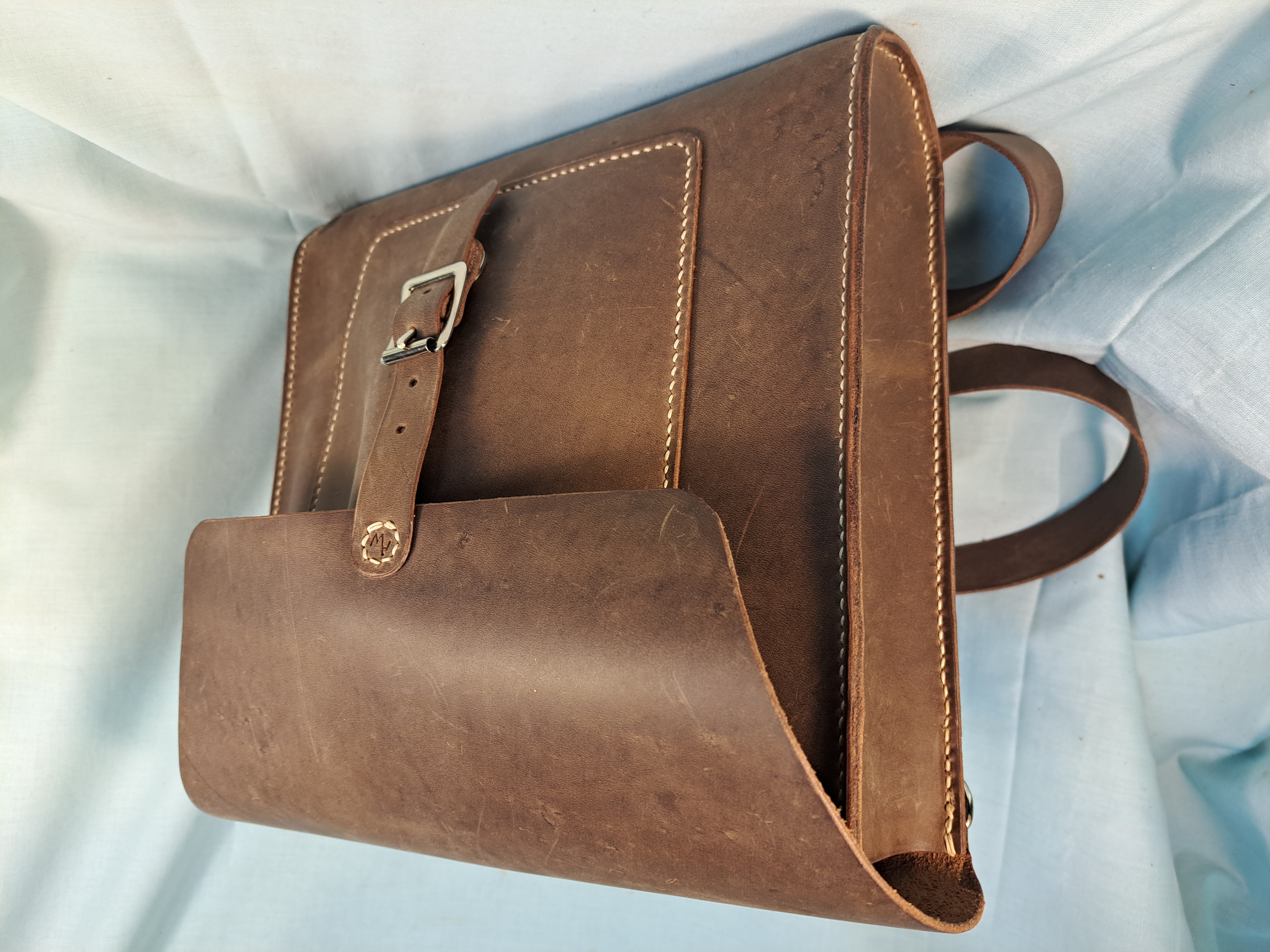 Custom brown leather bag with buckle