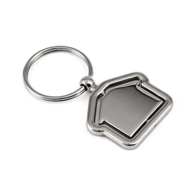 Smiling man wearing glasses and blue shirt in a modern coffee shop interior with bar counter and hanging lights.