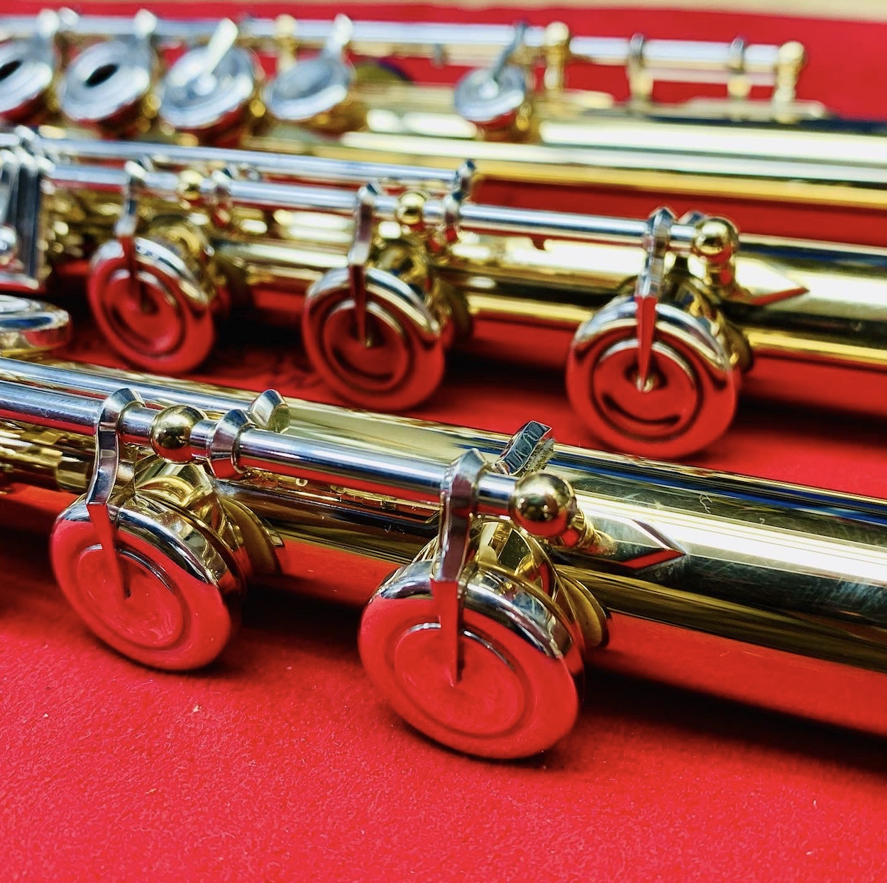 Close-up view of various woodwind instruments with brass and silver details.