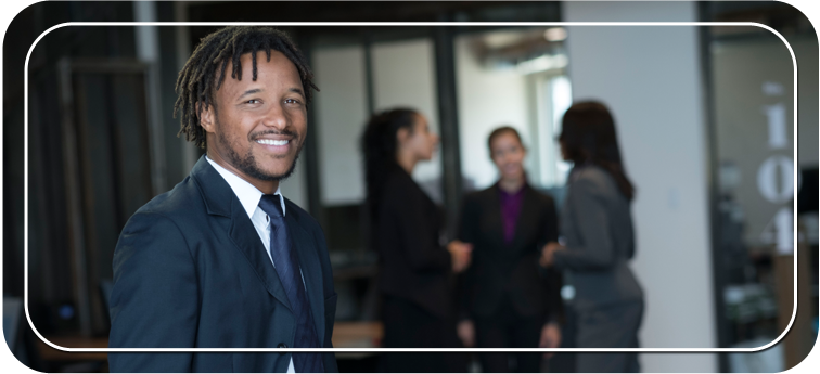 A man in a suit smiling at the camera
