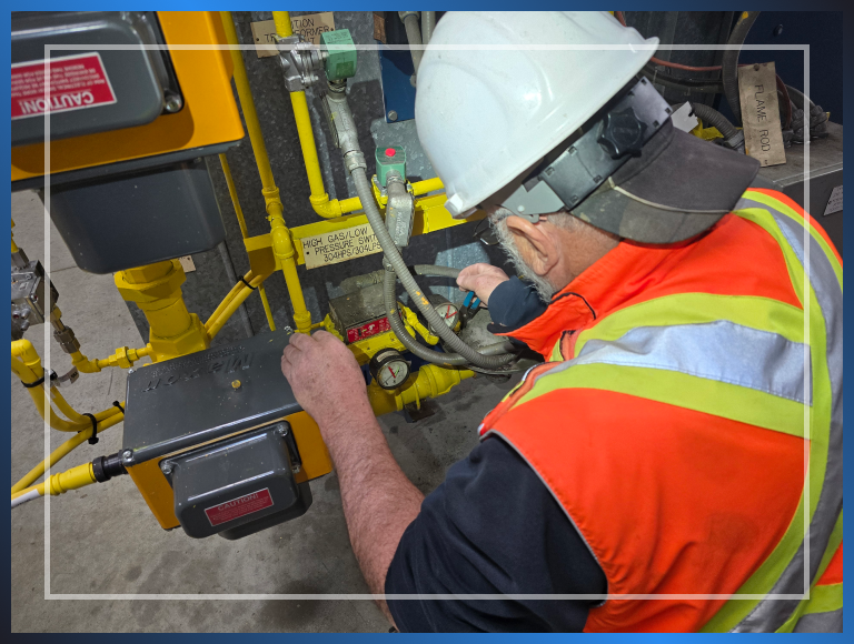 A man working with a hard hat and safety vest on