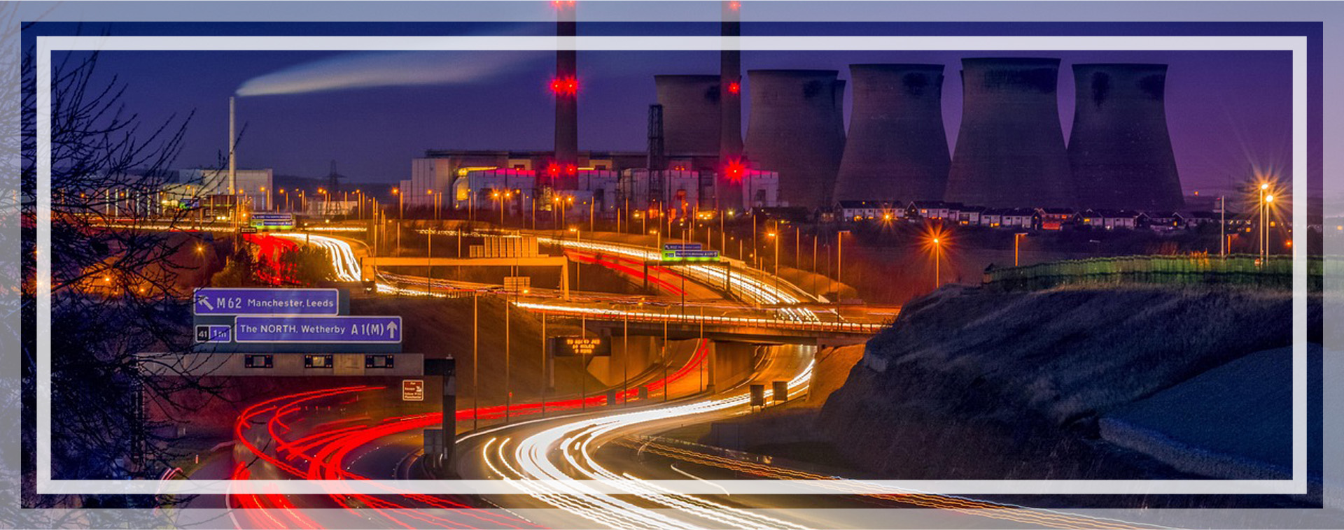 A city at night with blurry traffic driving down a highway