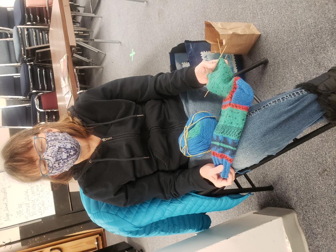 Shelley knitting colourful socks.