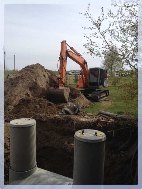 Orange tractor next to a large pile of dirt