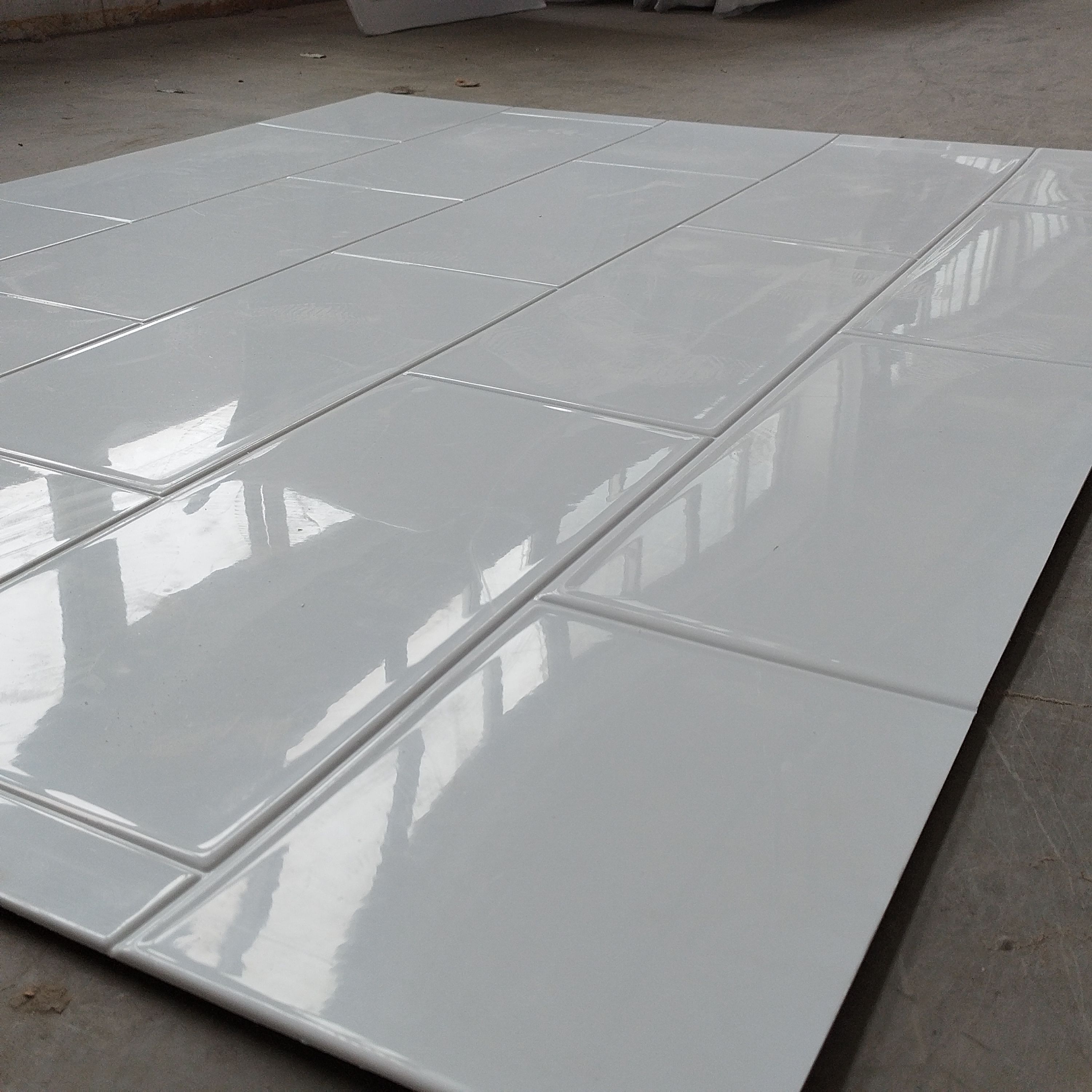 Modern bathroom interior with large windows, double sinks, wall-mounted shower, and indoor plants.