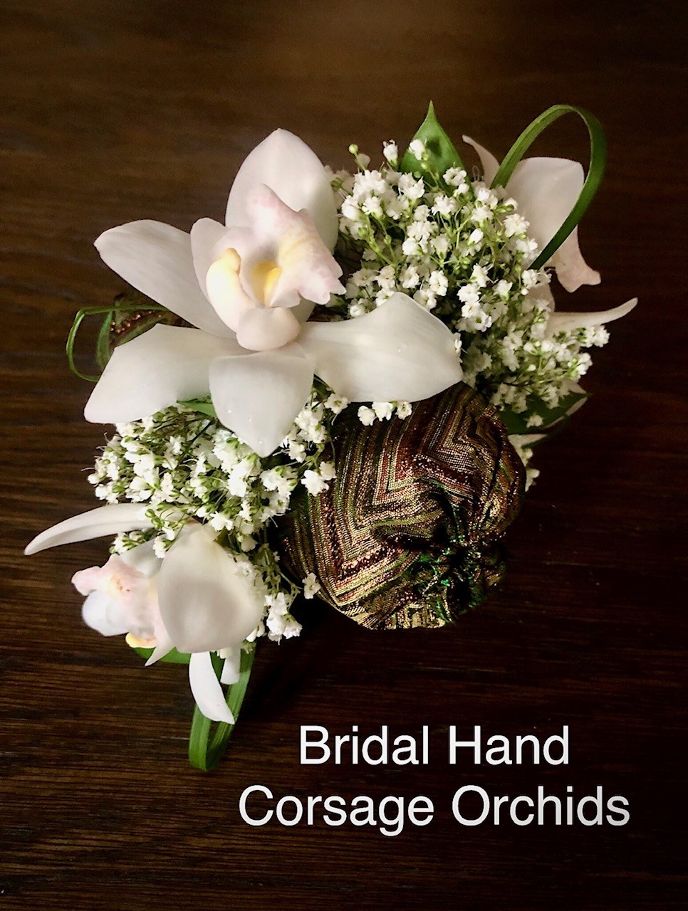 Bridal hand corsage white orchids $35 each 