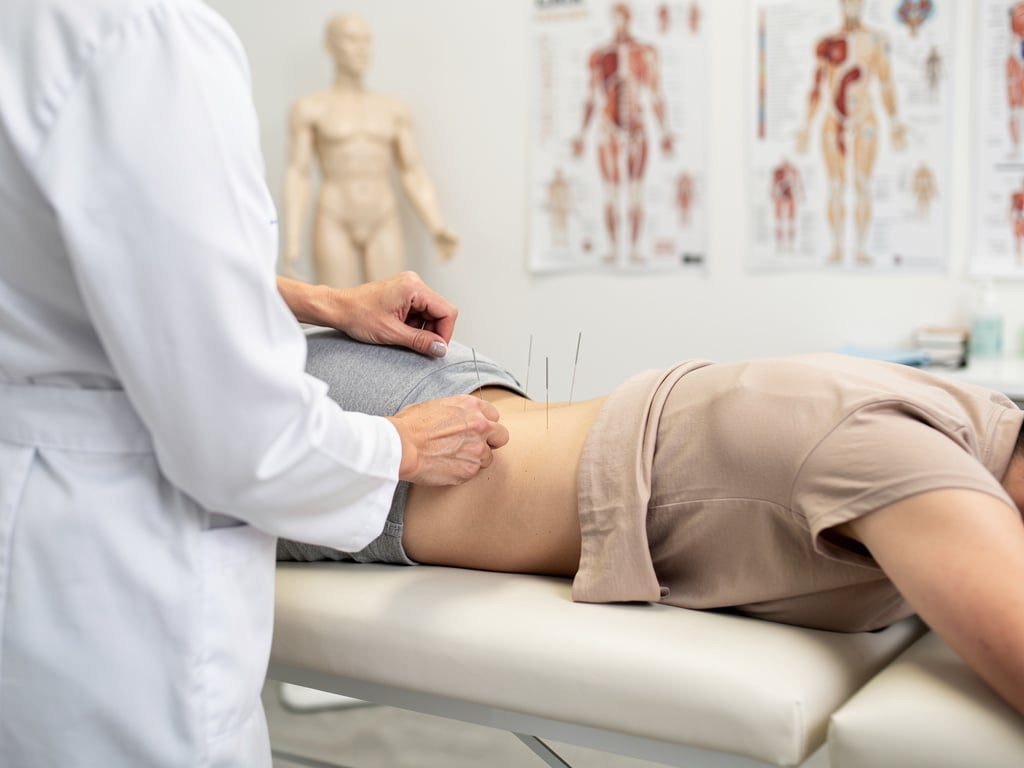 Senior doctor in a white coat standing in a physical therapy clinic with treatment table, medical tools, anatomy charts, and skeleton model Senior doctor in a white coat standing in a physical therapy clinic with treatment table, medical tools, anatomy charts, and skeleton model