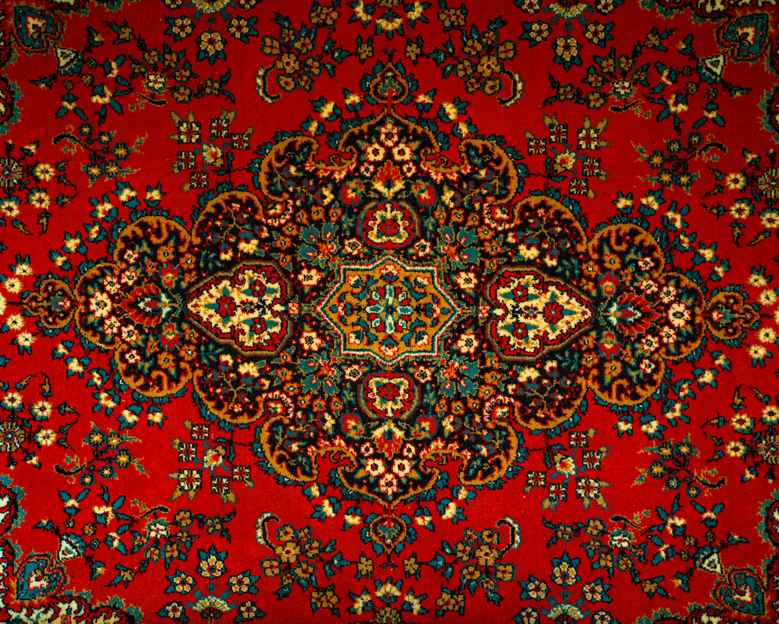 a red carpet with a colorful design on it a red carpet with a colorful design on it