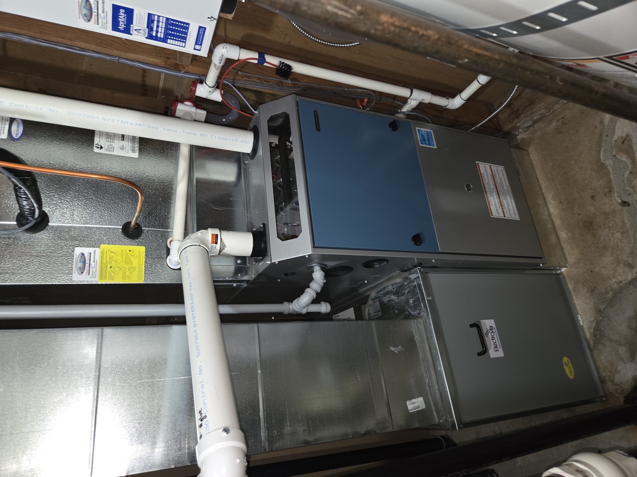Modern outdoor HVAC unit on patio near tranquil lake at sunset with mountains in background. Modern outdoor HVAC unit on patio near tranquil lake at sunset with mountains in background.