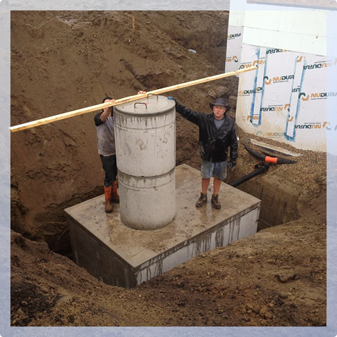 A man standing next to a large pump