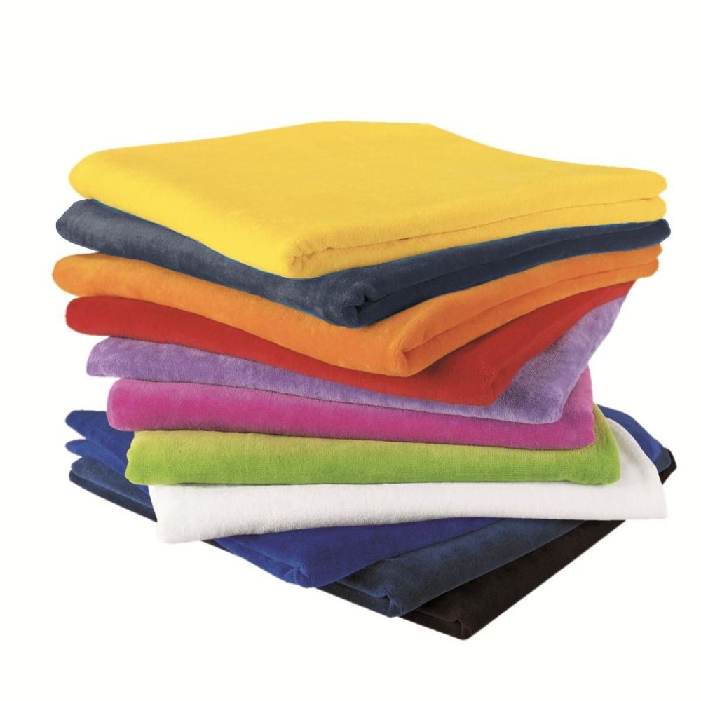 Three graphic t-shirts with text designs hanging on a wall with accessories including a red bag, hat, shorts, and fishing rod arranged decoratively.