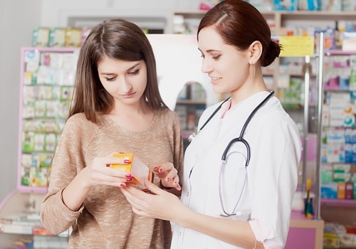 Pharmacist Showing Product To Client