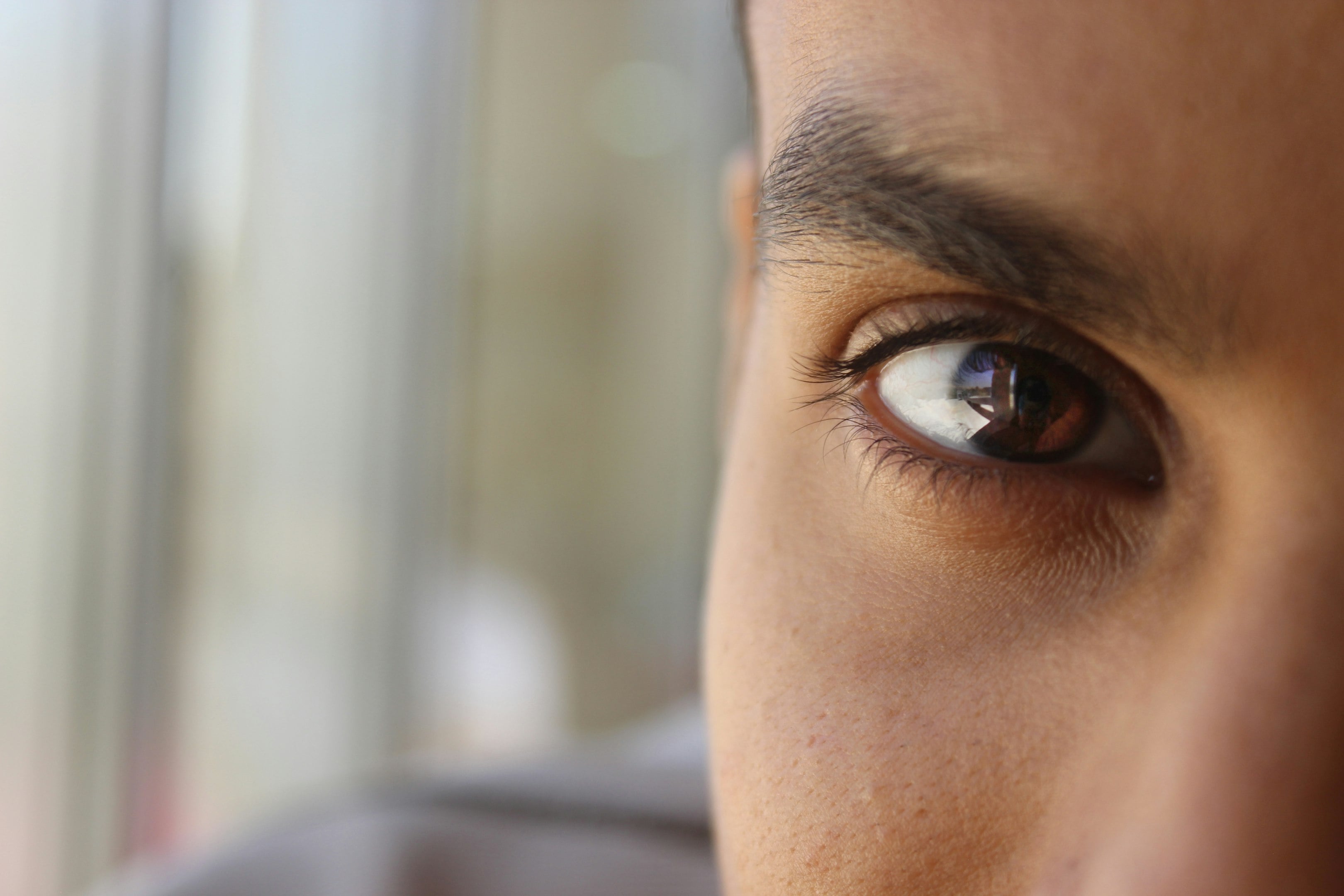 a close up of a person's eye with a blurry background