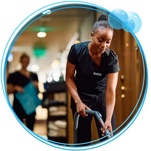 Two women cleaning a hallway.