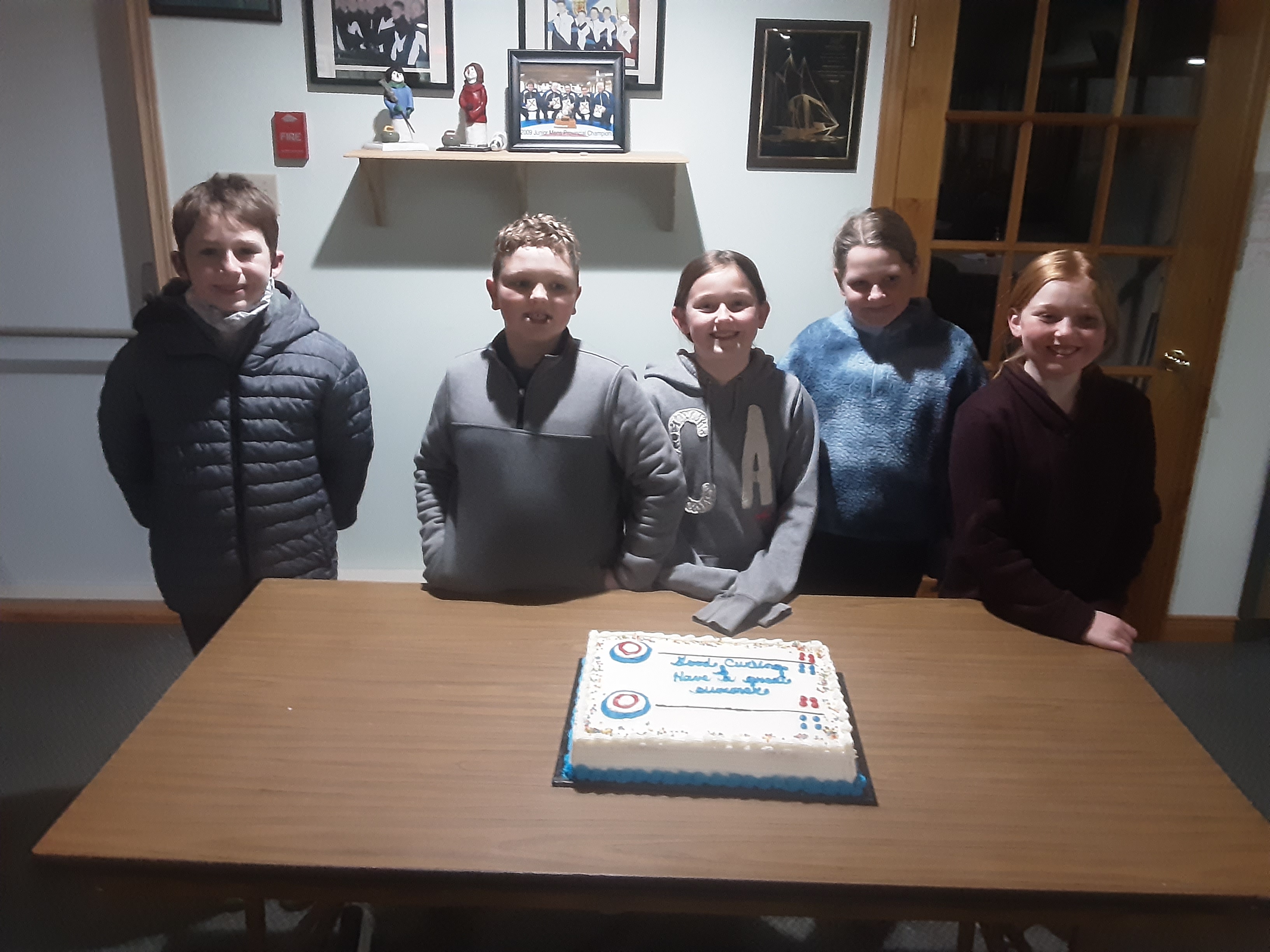 Junior Curlers celebrating their final night with some cake :) 