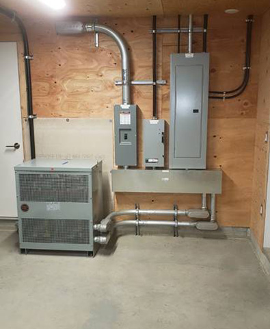 Electrical boxes in a basement area.