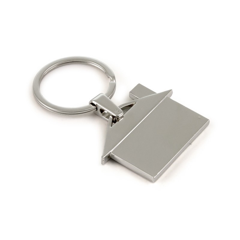 Three people in matching navy uniforms smiling in a modern office with shelves and a coffee table.