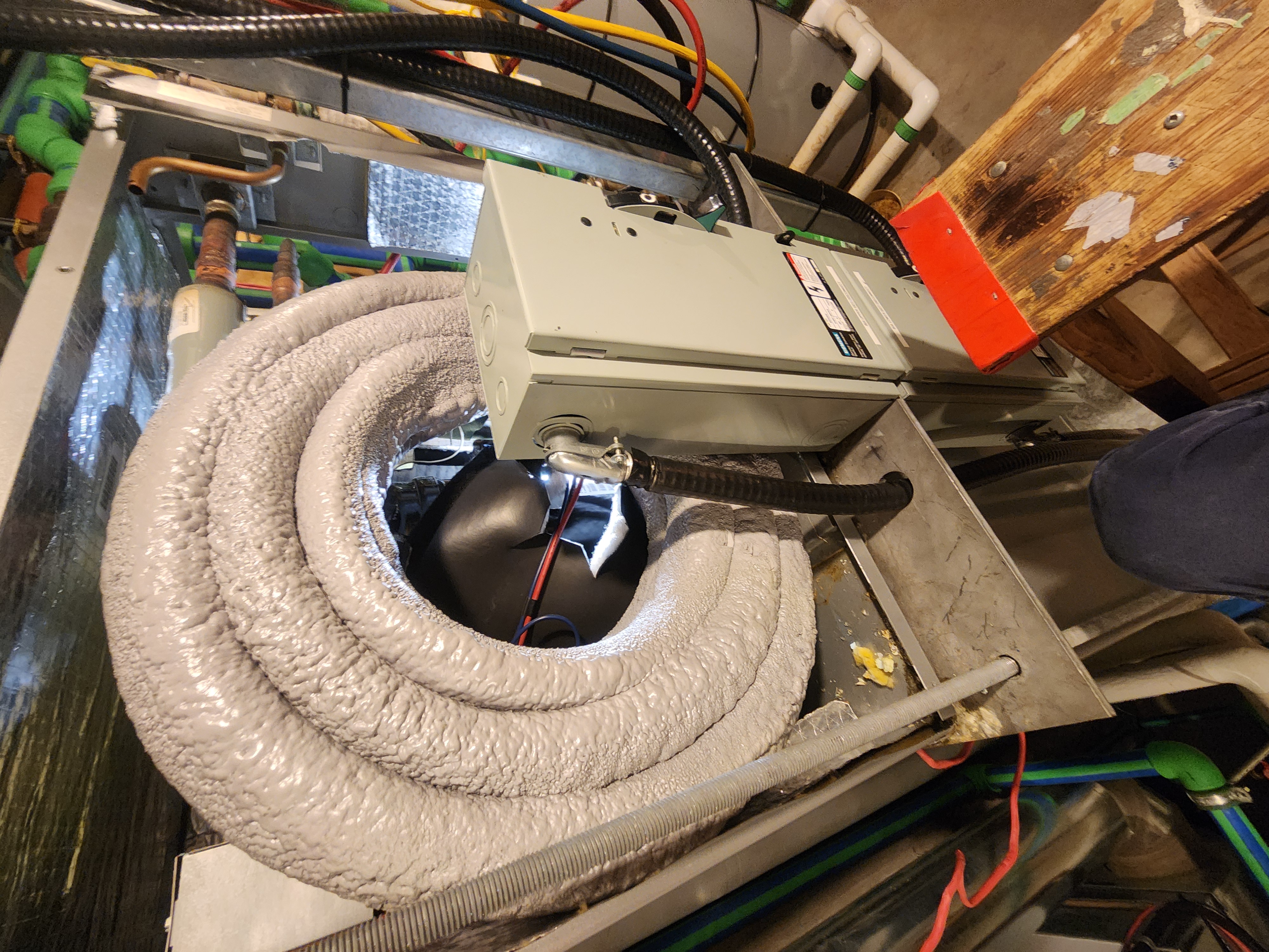 Modern farmhouse exterior with warm lighting, manicured lawn, large windows, and a spacious garage, at dusk.