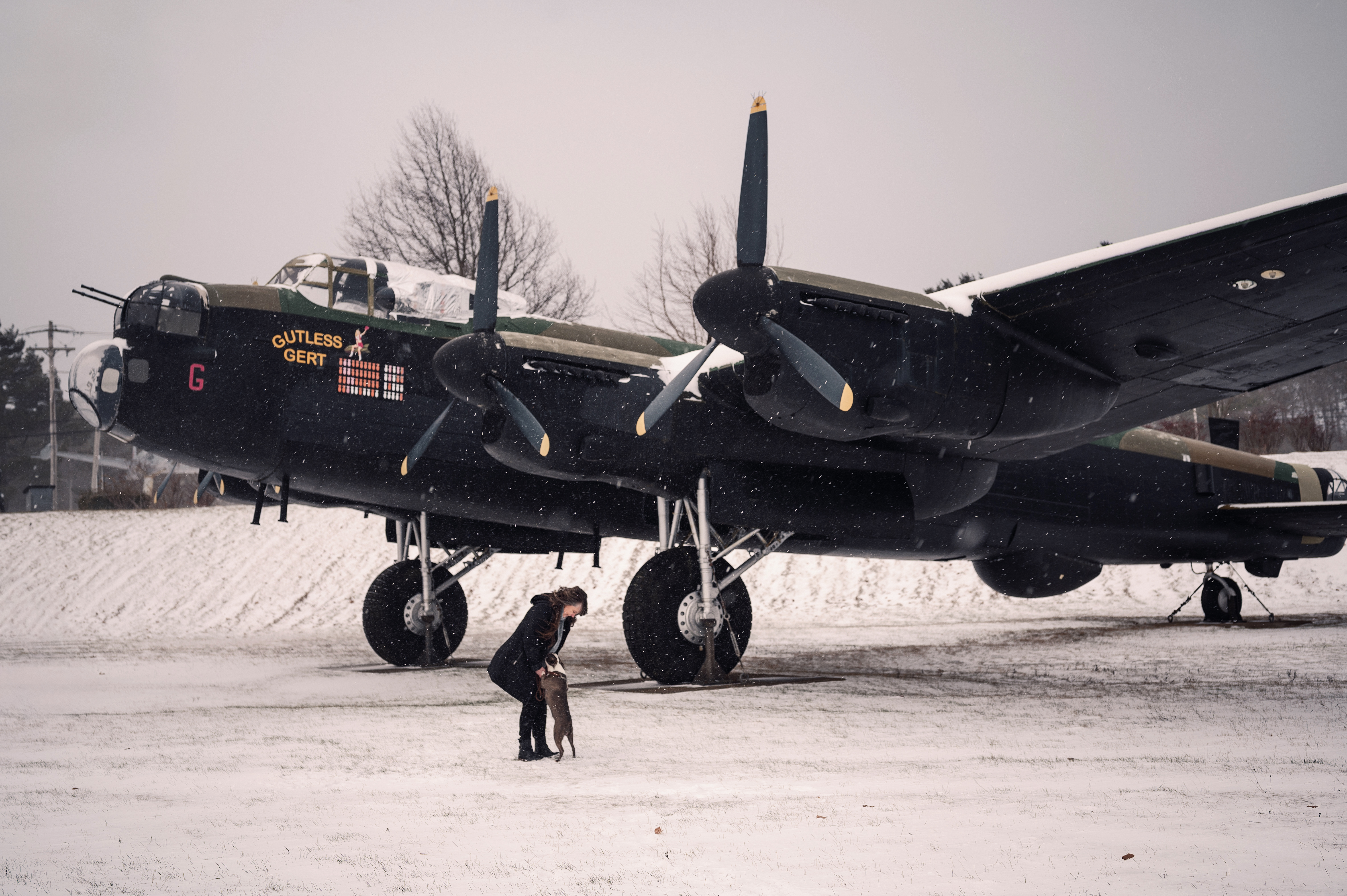 Smiling woman in business attire standing outdoors in an urban setting.