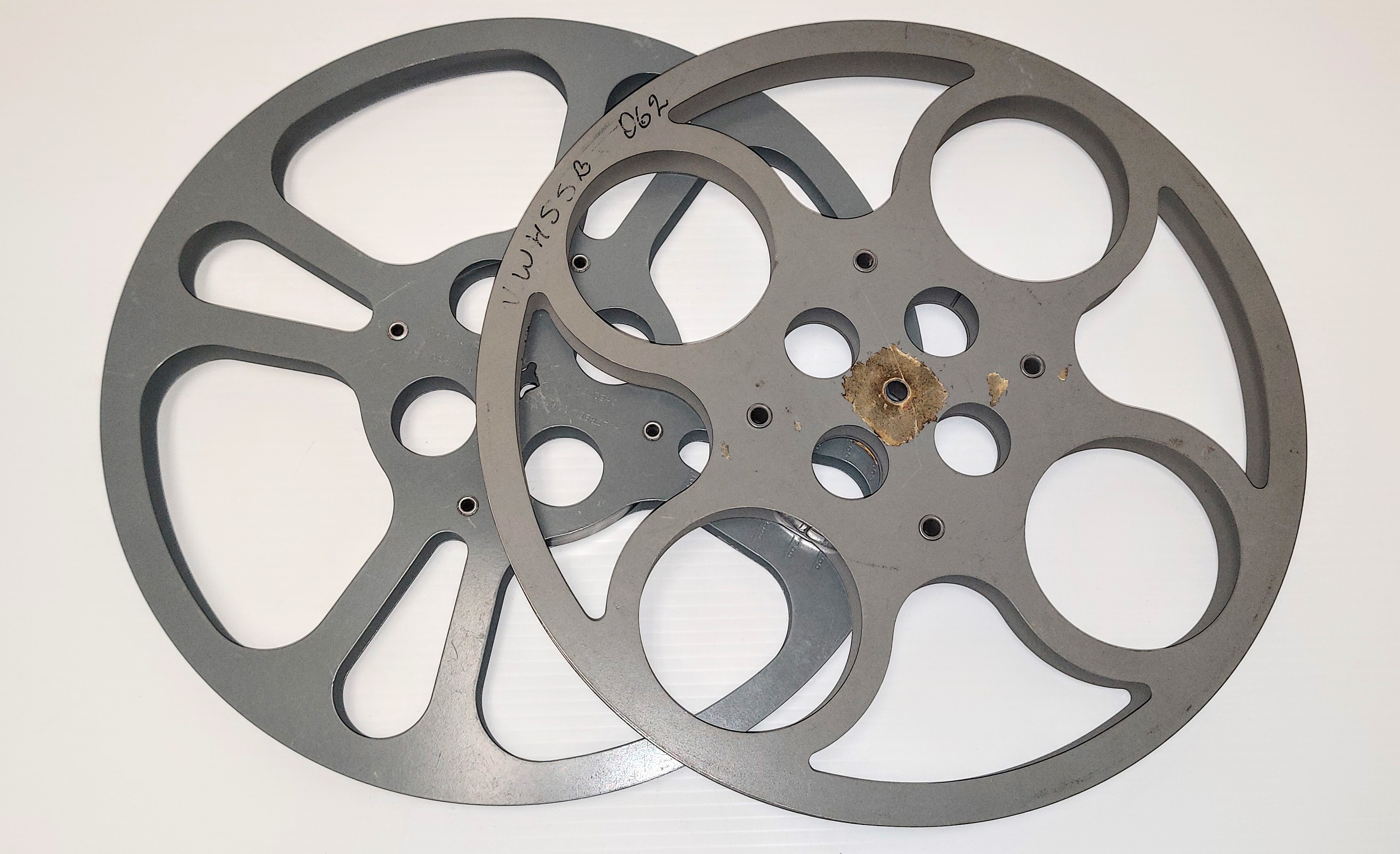 These are two 16mm film reels from the Fort Vermilion Recreation board. The reels held film 1200ft of film or just over 1/2 hour of footage. If a film was longer - a "projectionist" would have to switch out the reels to continue playing the film. If the film was not inserted correctly the image could be upside down, played back wards or reels played in the wrong order. This reel and projector system is what was used at the movie theatre in Fort Vermilion during the 60's - which was known to have the mishaps as noted above!
2010.45.06, 210.45.08 / Fort Vermilion Recreation Board