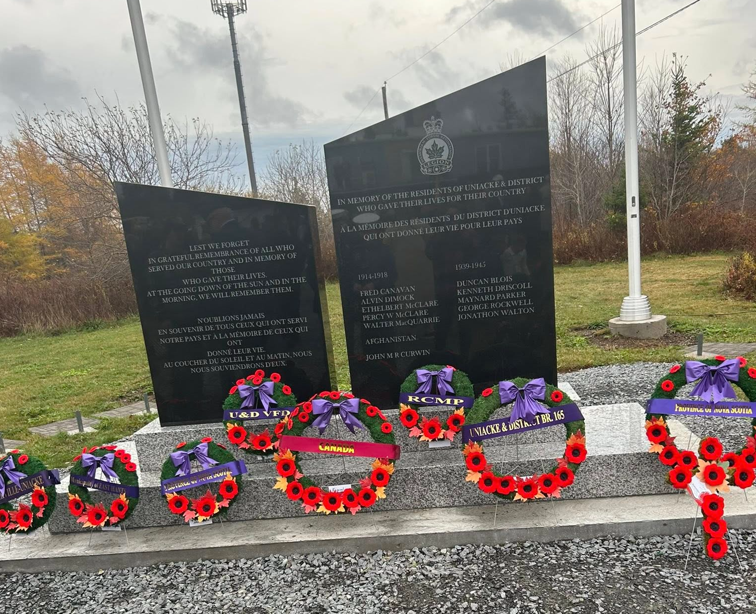 a group of men in red uniforms marching down a street