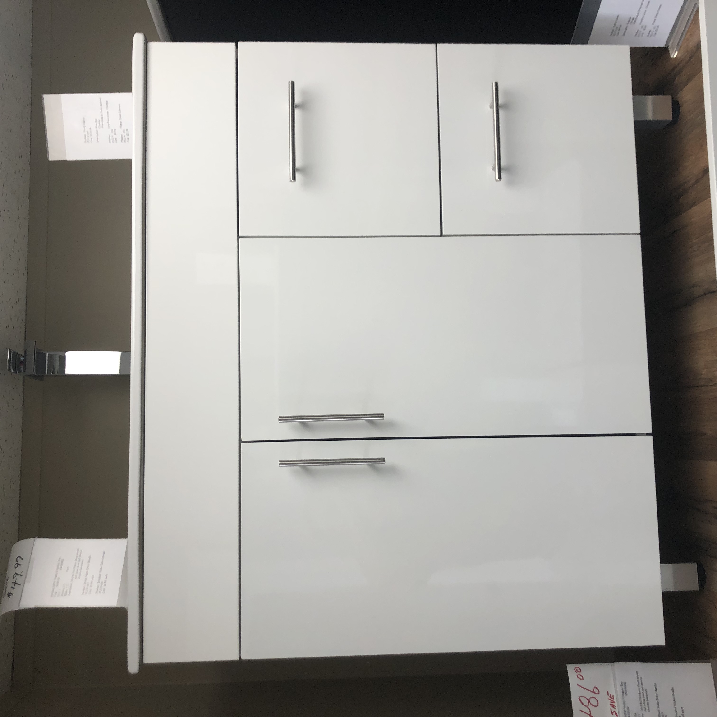 Modern minimalist bathroom with freestanding bathtub, glass shower, large window, and vanity with double sinks.