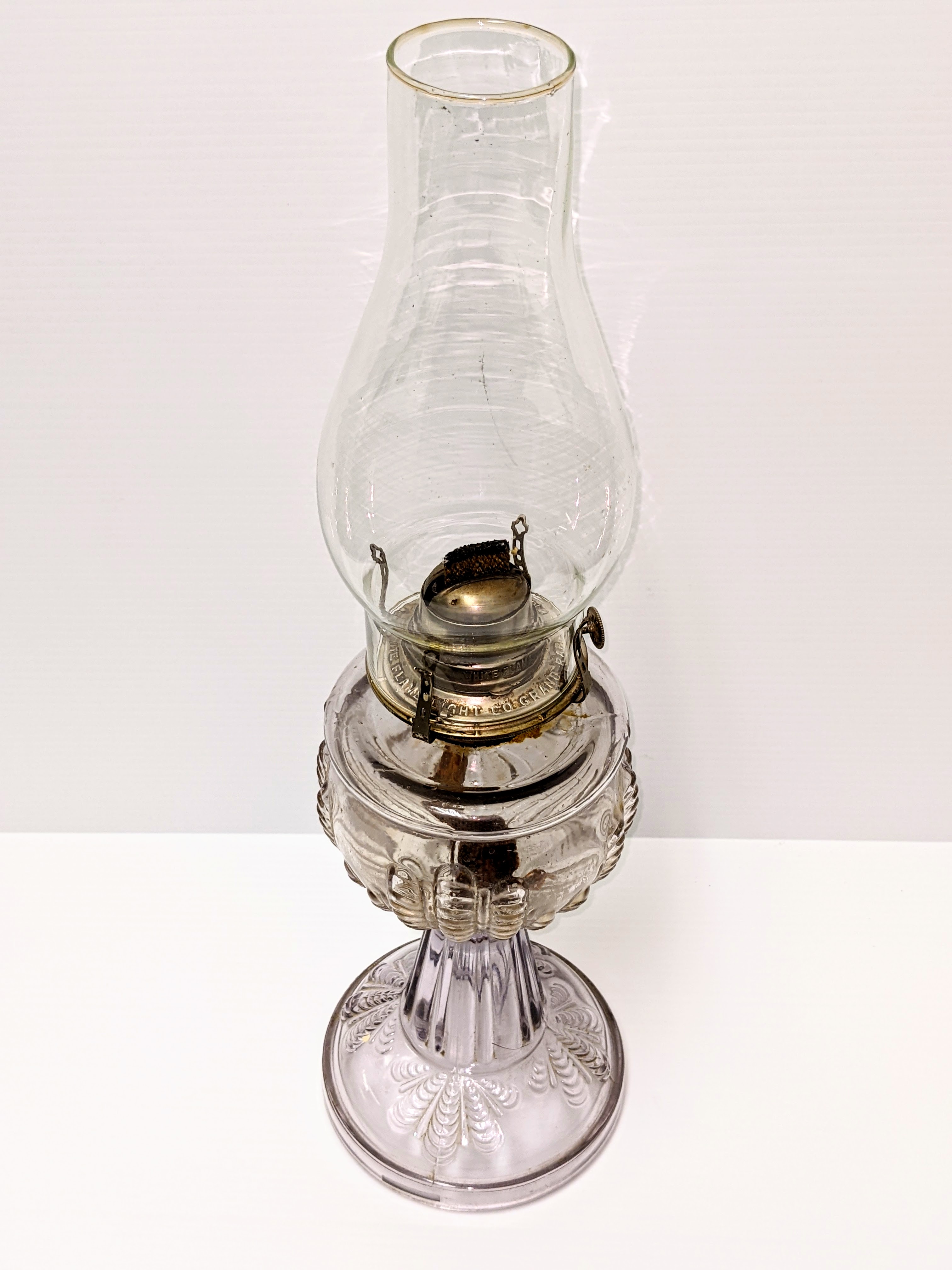Today is International Day of Light! In recognition of this we have picked a oil lamp as our artifact of the week! This particular lamp was made by the "White Light company" and its decorative design is known as "Turkey Foot". It is difficult to see in the picture but the lamp does have a purple hue to its glass base. We have come a long way with our use of light making devices; from this simple lantern used only as a light source to laser light which contributes to medical, industrial, and research fields.
16/05/2022
995.2.50 / Bell, Lorna