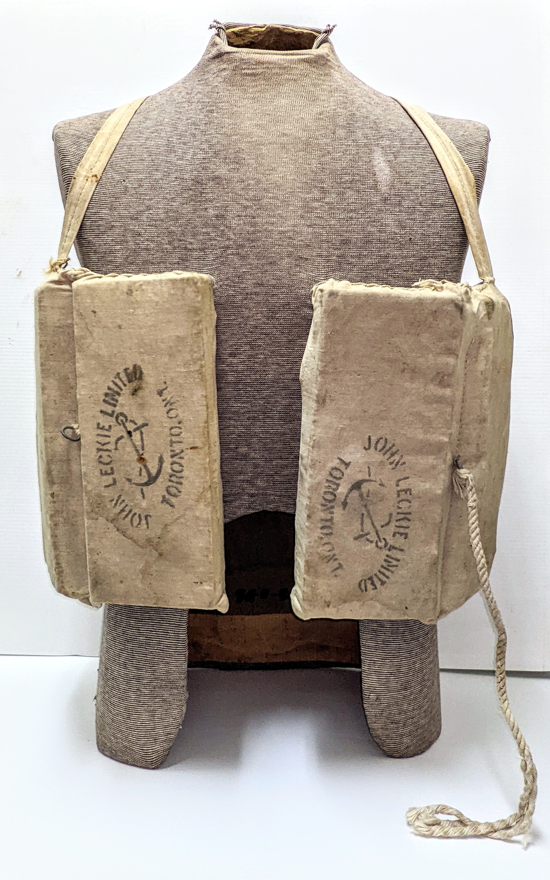 This bulky looking attire is a canvas and cork lifejacket. Made at the turn of the 20th century, this flotation device was used on the SS Peace River which was built in Fort Vermilion in 1905. The boat was operated by the Hudson's Bay company from 1905 - 1916 when it was dry docked and dismantled in Fort Vermilion. The two stamps on the front label the life jacket as a product of John Leckie LTD Toronto - a company specializing in fishing supplies! On the back side is a "Peace River" stamp.
2002.247.01 / Fort Vermilion Historical Society
