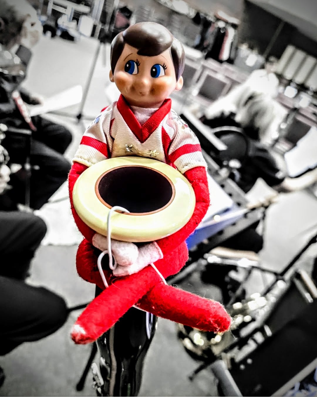 image of a an elf in a white and red outfit sitting in a bassoon.