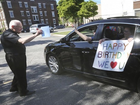 Archdeacon Matthewman greets a carload of participants. DAN JANISSE photo