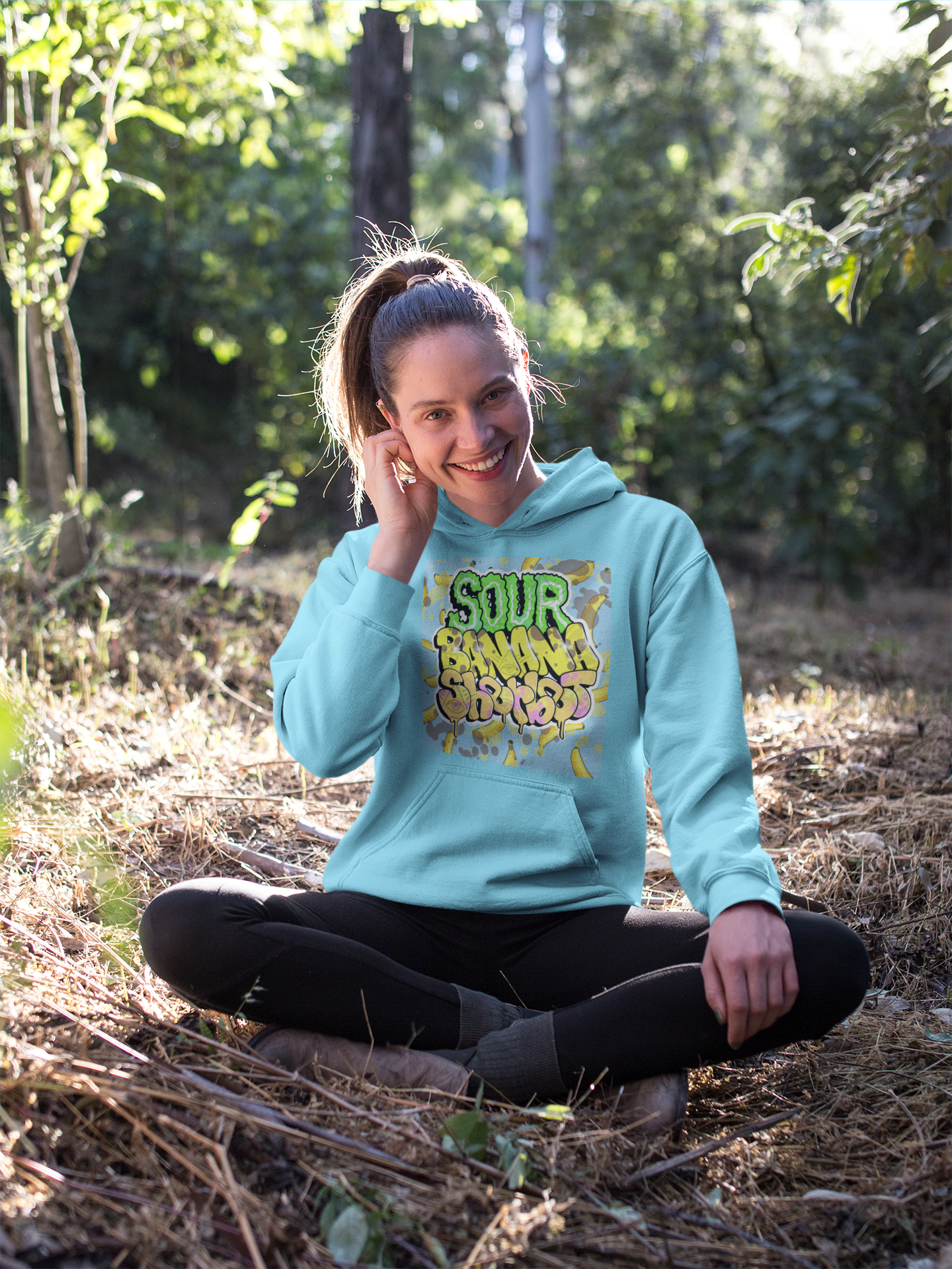 https://0901.nccdn.net/4_2/000/000/087/15c/happy-blonde-girl-sitting-in-the-forest-wearing-a-pullover-hoodi.png