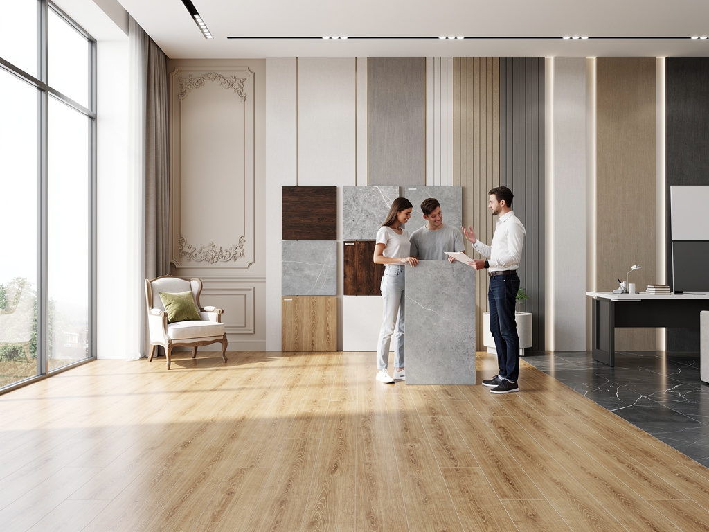 Interior design showroom with consultant showing flooring and wall material samples to a couple